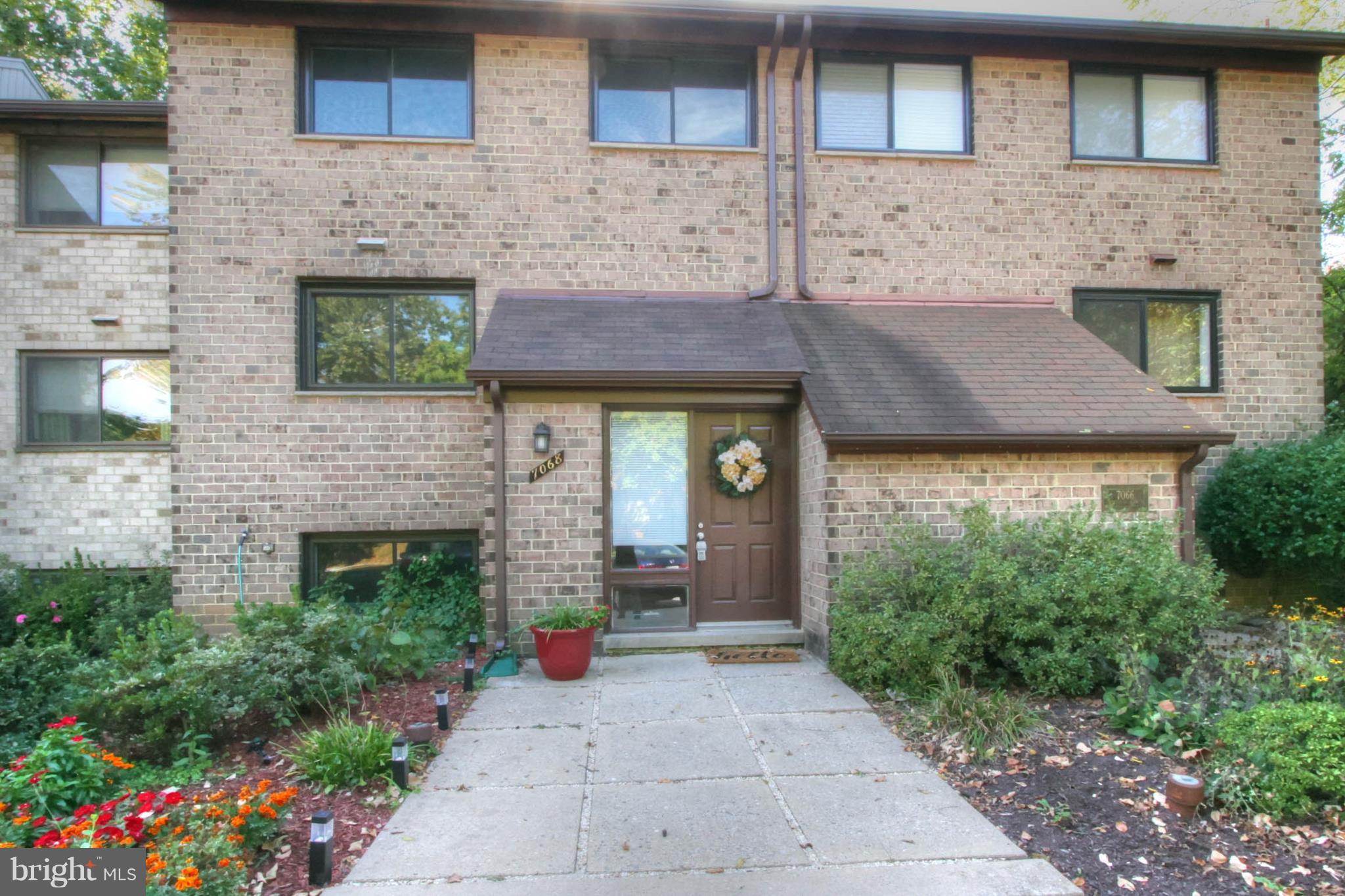 7068 Winter Rose Path Columbia, MD 21045 - Photo 26 of 30 a front view of a house with a yard