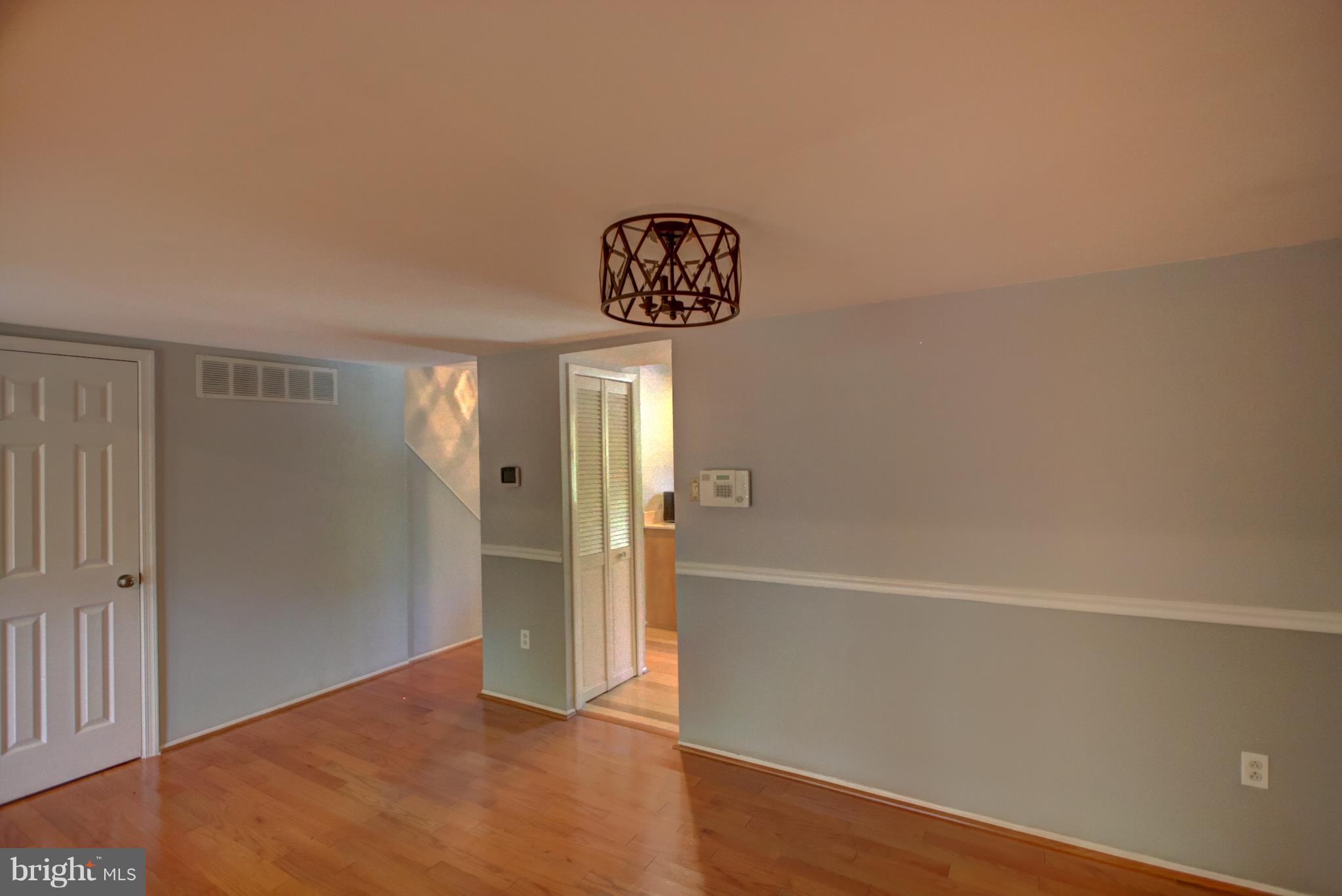 7068 Winter Rose Path Columbia, MD 21045 - Photo 6 of 30 a view of a hallway with wooden floor