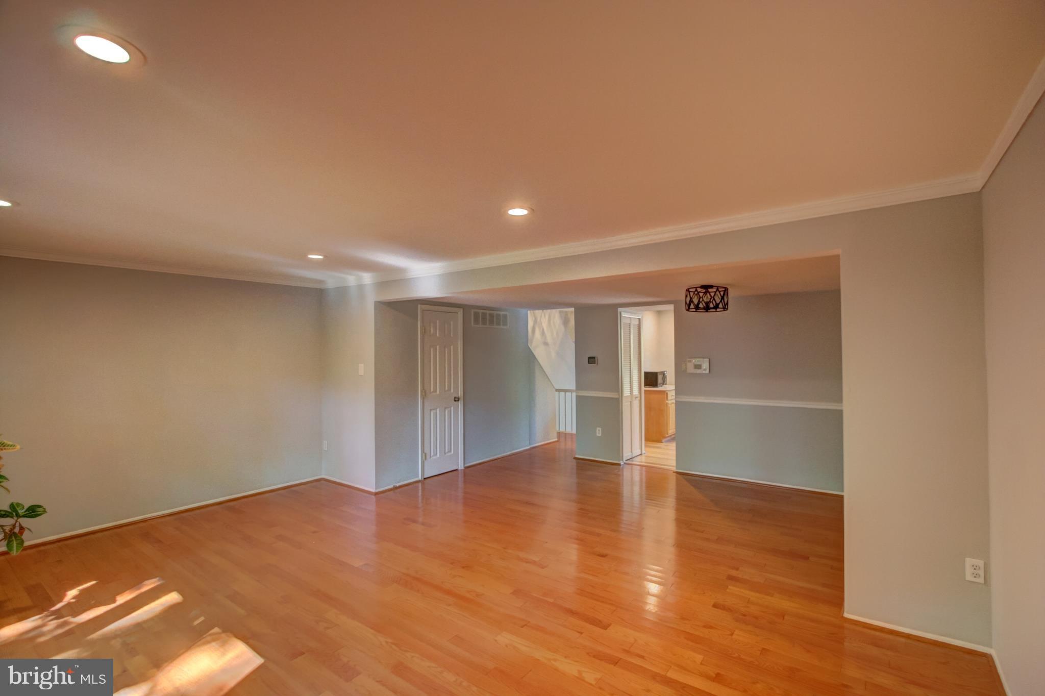 7068 Winter Rose Path Columbia, MD 21045 - Photo 8 of 30 a view of an empty room with wooden floor
