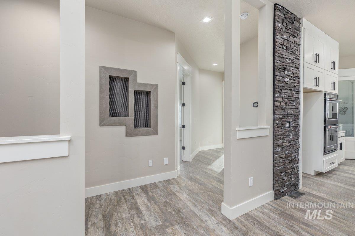 5990 West View Drive Meridian, ID 83642 - Photo 17 of 50 Hallway with baseboards and light wood-style flooring