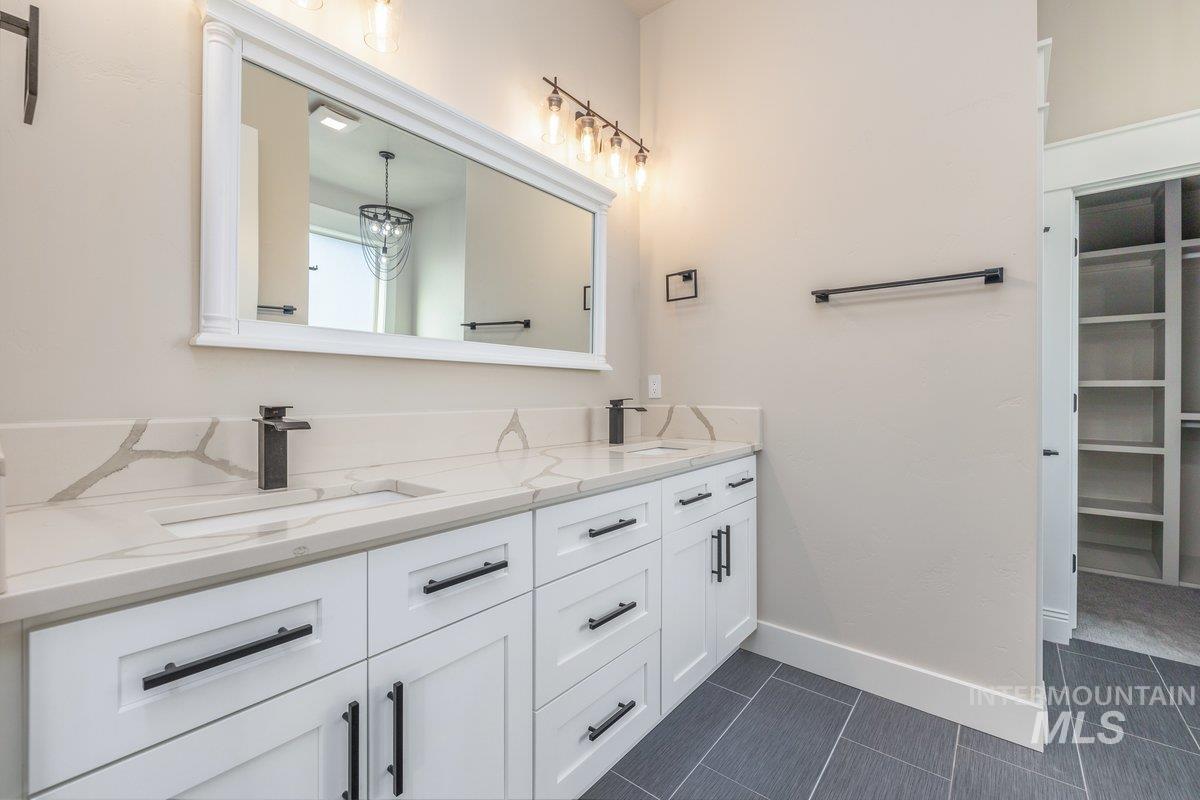 5990 West View Drive Meridian, ID 83642 - Photo 19 of 50 Full bathroom featuring double vanity and a walk in closet