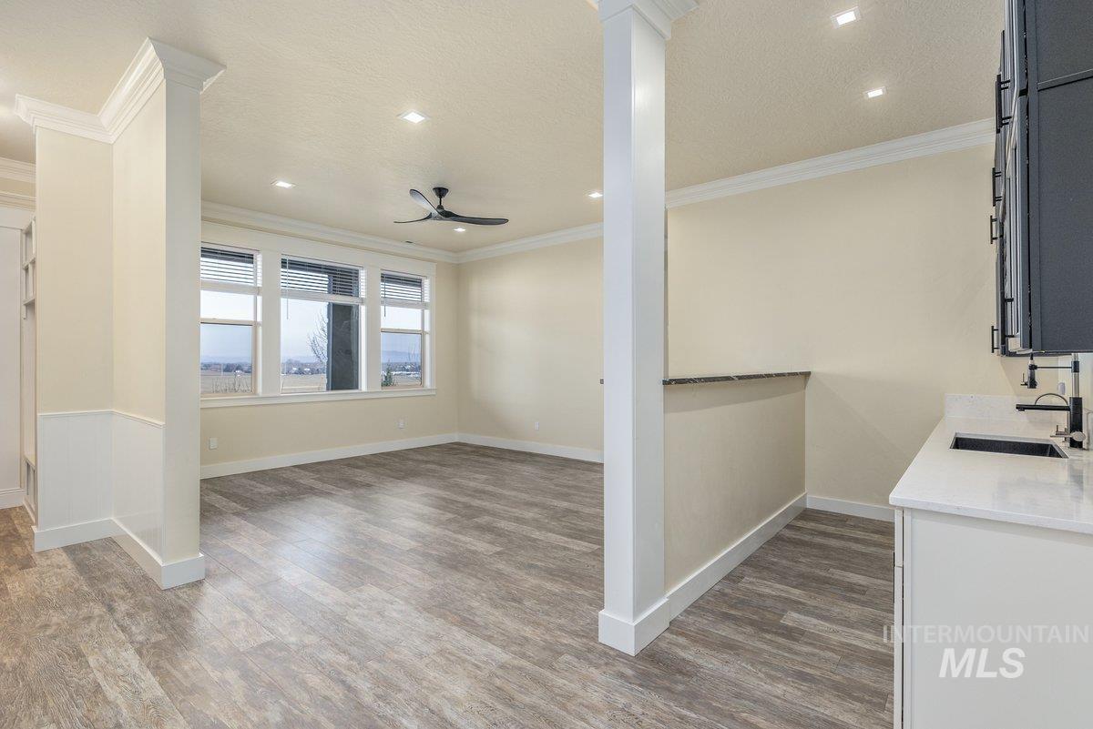 5990 West View Drive Meridian, ID 83642 - Photo 28 of 50 Kitchen with light stone counters, dark wood-style flooring, ceiling fan, ornamental molding, and recessed lighting