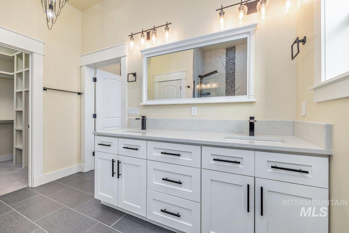 5990 West View Drive Meridian, ID 83642 - Photo 30 of 50 Bathroom with double vanity, a shower, and a walk in closet