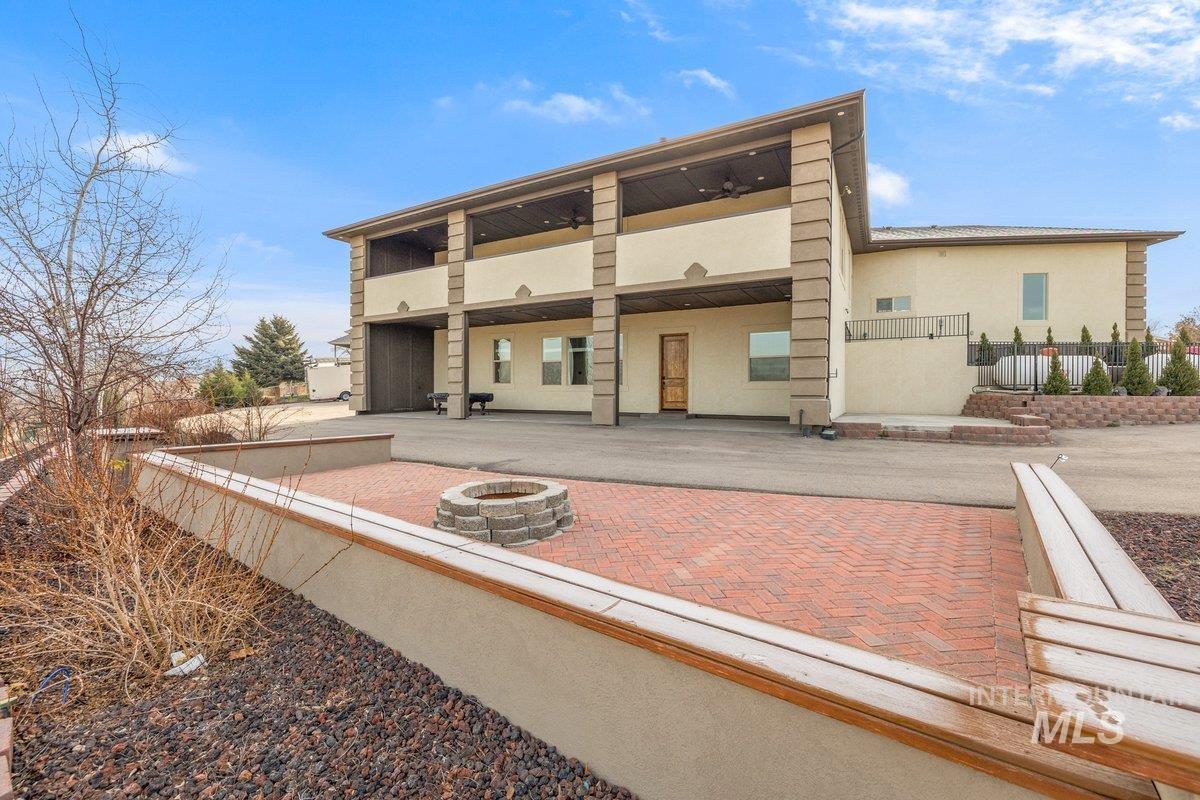 5990 West View Drive Meridian, ID 83642 - Photo 43 of 50 Rear view of property featuring an outdoor fire pit, stucco siding, a balcony, and a patio