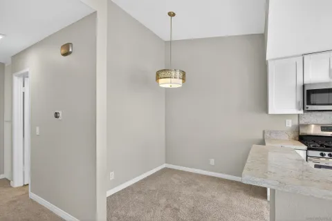 a bathroom with a sink a light fixture and a toilet