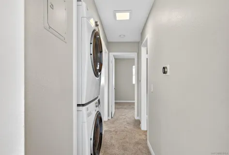 a view of a hallway with washer and dryer