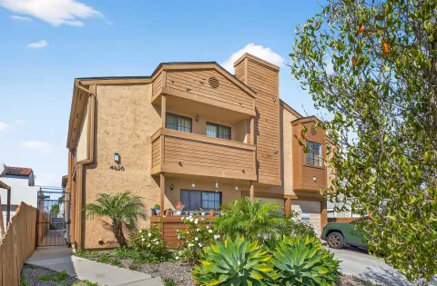 a view of a big building with plants and garden
