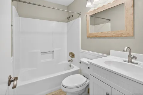 a bathroom with a sink toilet and shower