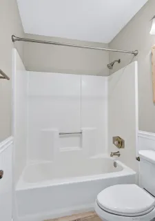 a bathroom with a toilet and a bath tub