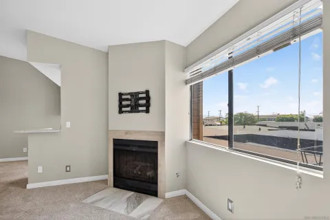 a view of a living room with furniture and a fireplace