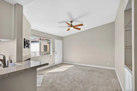 a view of a kitchen with sink and a refrigerator