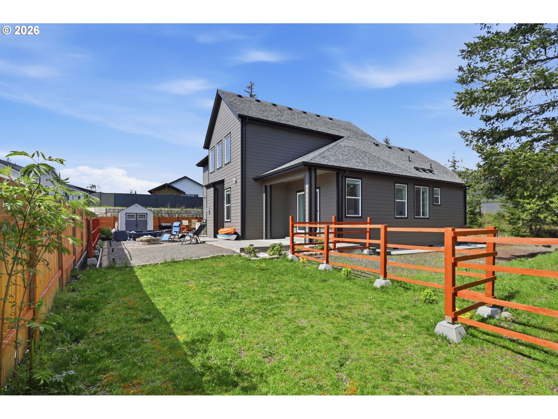 1226 Northwest Iman Loop Road Stevenson, WA 98648 - Photo 31 of 39 a front view of a house with a yard porch and wooden fence