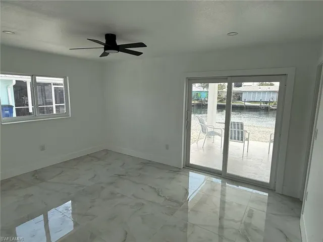 an empty room with windows and closet