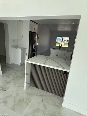 a bedroom with a bed and a tv on the wall