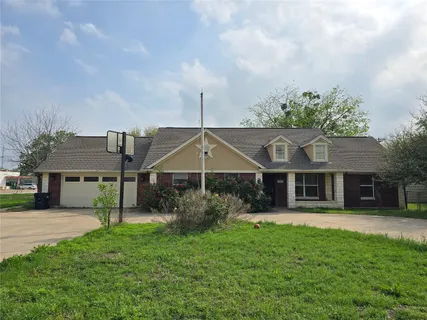 a aerial view of a house with a big yard potted plants and large tree