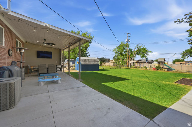 66 South 425 West Bountiful, UT 84010 - Photo 3 of 25 Expansive concrete patio featuring a covered section with a ceiling fan and string lighting