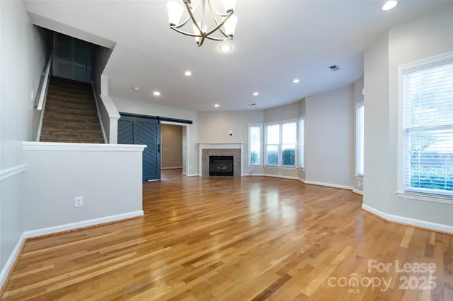 a view of empty room with wooden floor and fireplace