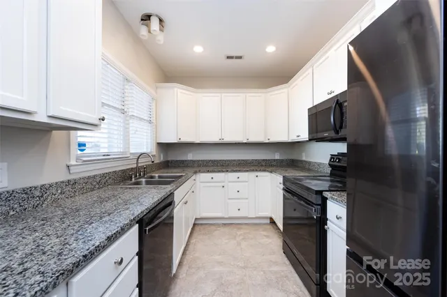 a kitchen with a sink stove and cabinets