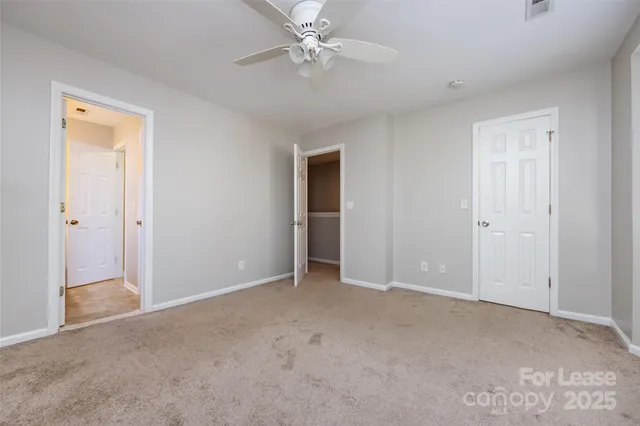 a view of an empty room with a ceiling fan