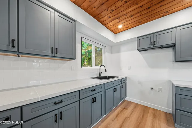 a kitchen with a sink and cabinets