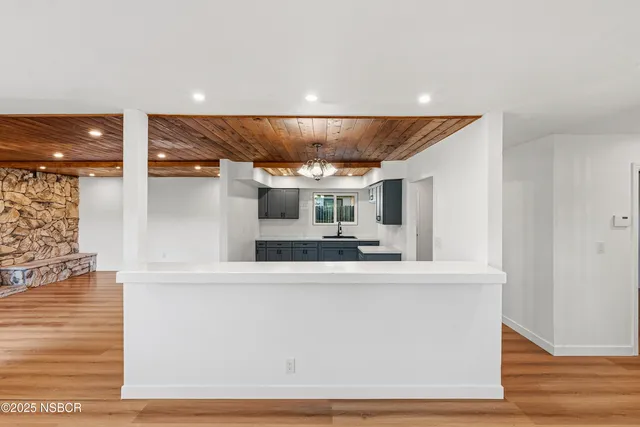 a large white kitchen with a large window