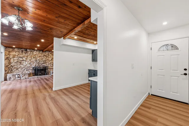 a view of a hallway with wooden floor