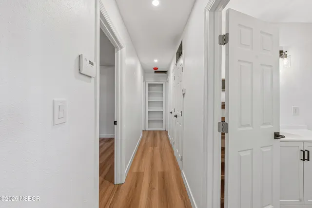 a view of hallway with wooden floor
