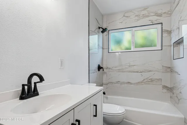 a bathroom with a sink a toilet and a bathtub