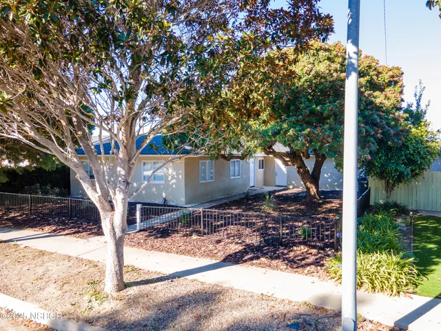 a wooden bench sitting in front of a building