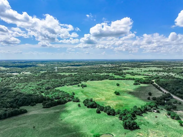 a view of a big yard with lots of green space