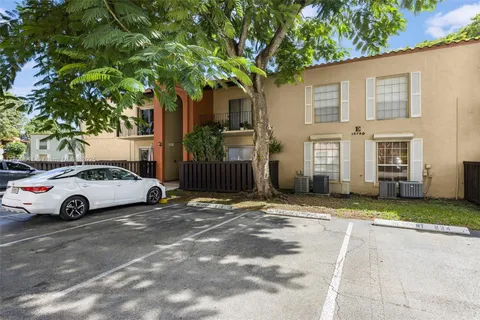 a view of a street with a building and a street sign