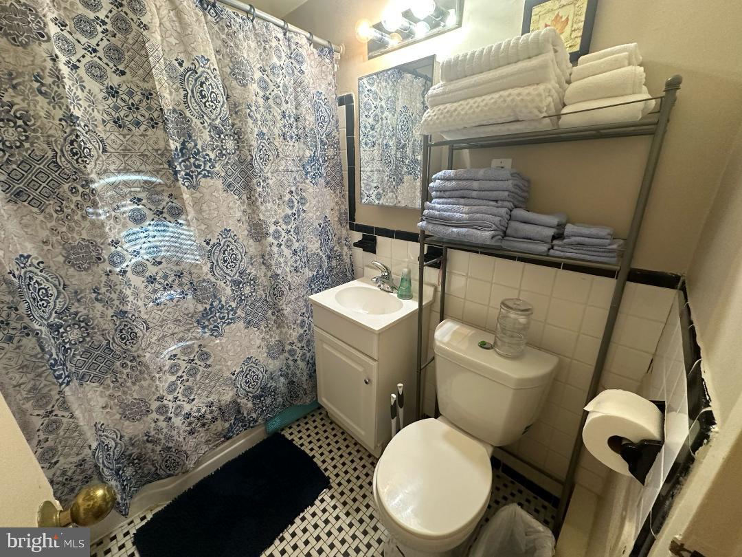 2141 I Street Northwest, Unit 615 Washington, DC 20037 - Photo 11 of 16 a bathroom with a toilet and a sink