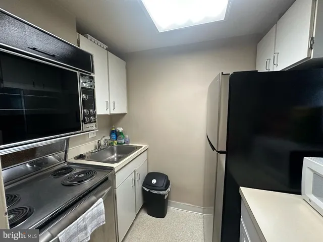 a kitchen with a refrigerator and a stove