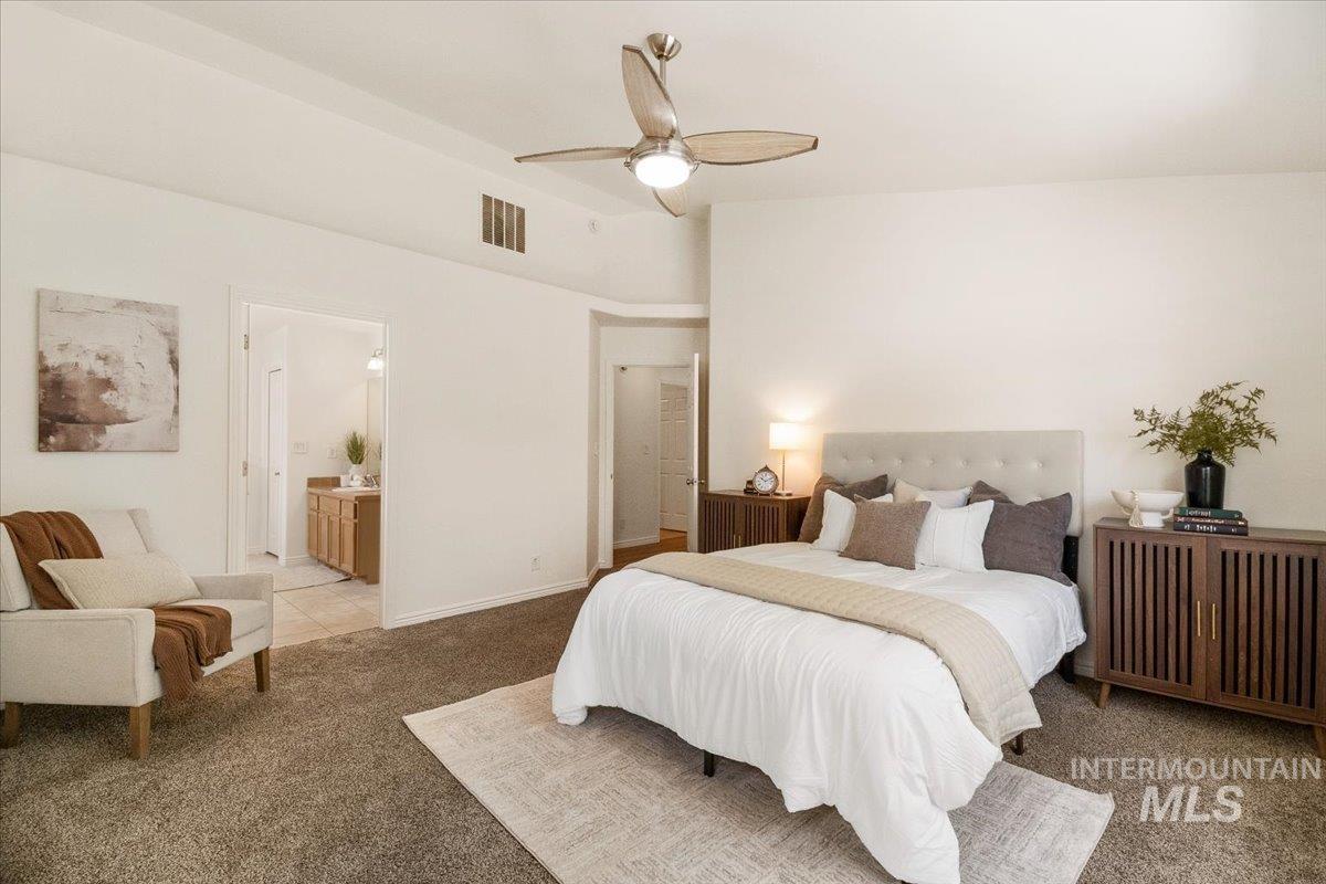 2032 Talus Loop Twin Falls, ID 83301 - Photo 32 of 43 Spacious bedroom featuring vaulted ceilings, a ceiling fan with integrated lighting, and plush carpeting