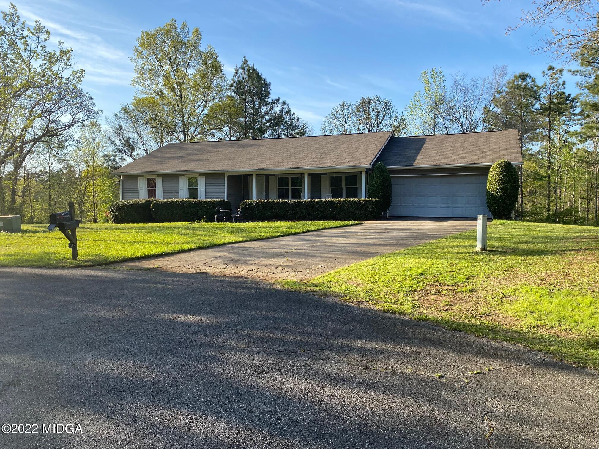 a view of a house with swimming pool and a yard