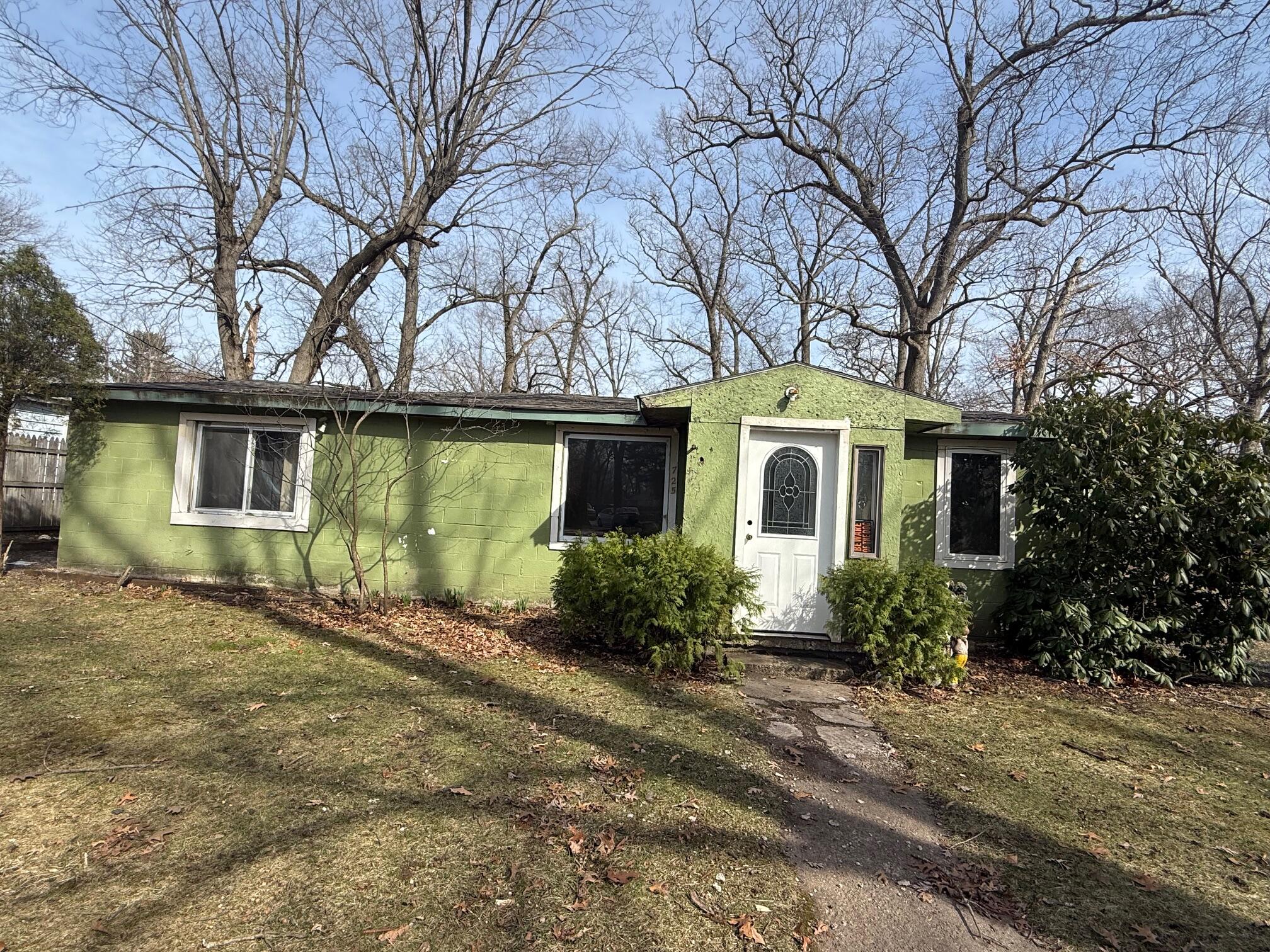 725 Minnie Street Michigan City, IN 46360 - Photo 2 of 12 a front view of a house with a garden