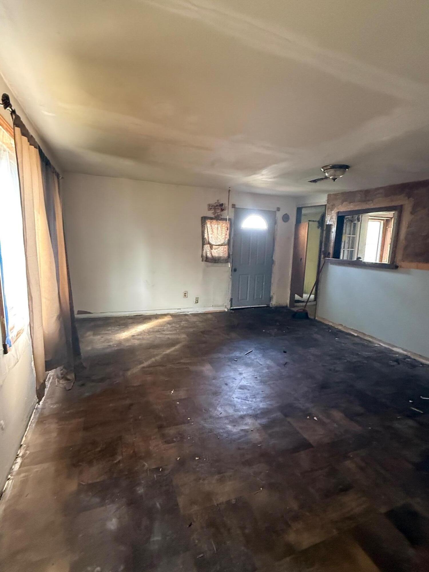 725 Minnie Street Michigan City, IN 46360 - Photo 5 of 12 an empty room with wooden floor and windows