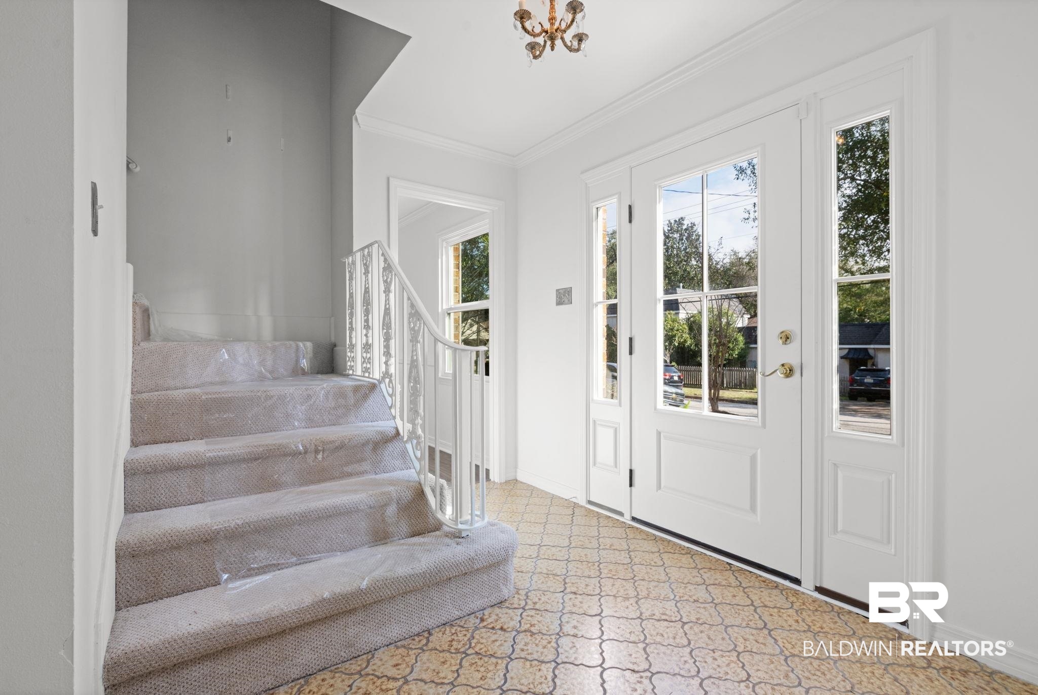 511 Wacker Lane North Mobile, AL 36608 - Photo 8 of 45 Foyer entrance with stairway, crown molding, and tile patterned floors