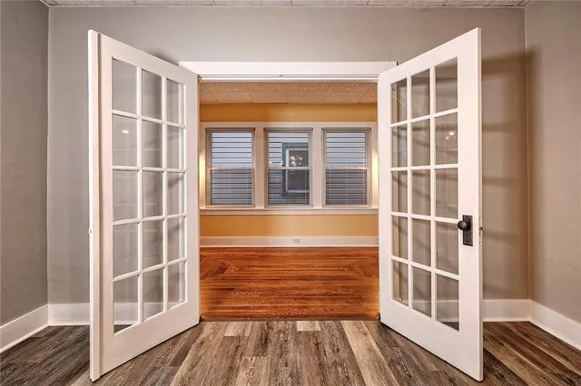a view of a balcony with wooden floor and fence