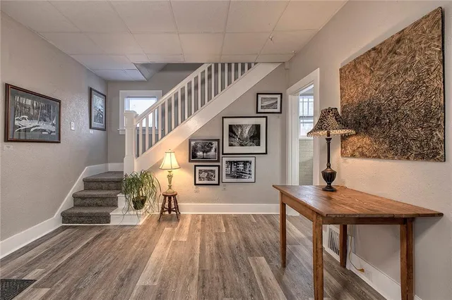 a view of entryway and hall with wooden floor