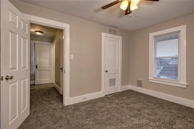 a view of an empty room with a window