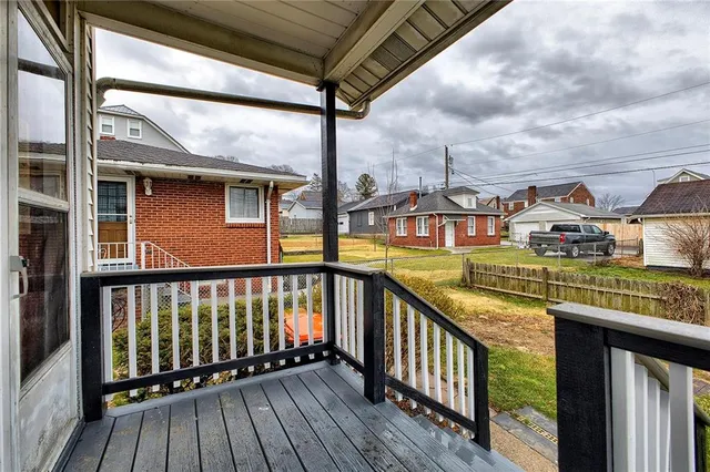 a view of an house with backyard space and balcony