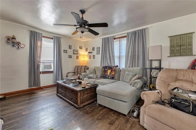 a livingroom with dining area a chandelier a wooden table and chairs