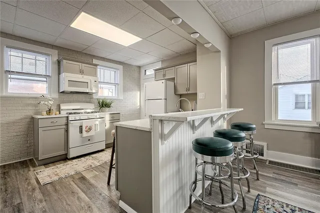 a kitchen with furniture a window and stainless steel appliances