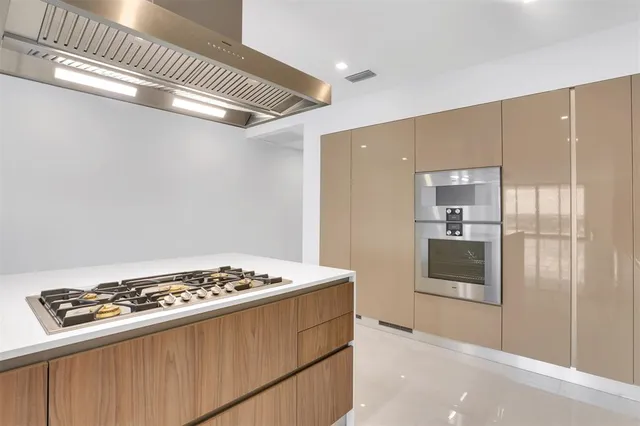 a kitchen with stainless steel appliances a sink and a refrigerator