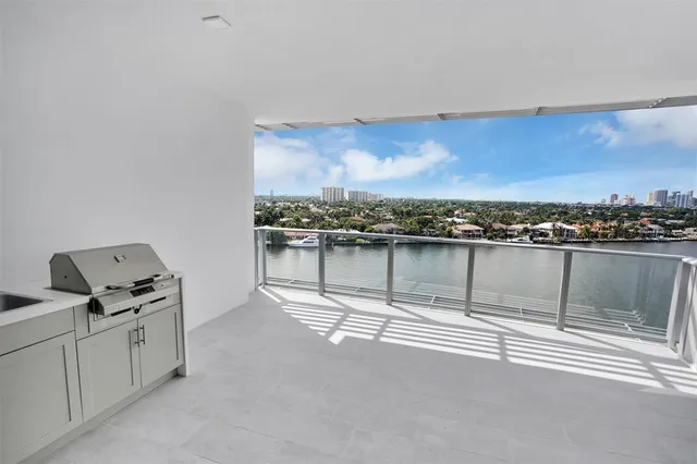 a living room with furniture a flat screen tv and kitchen view