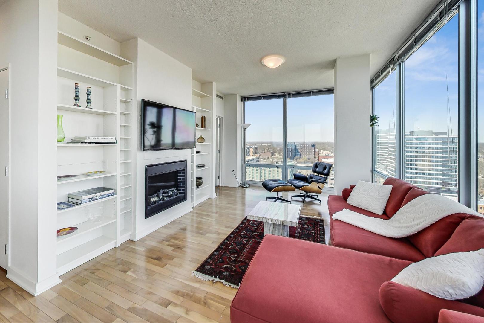 800 Elgin Road, Unit PH02 Evanston, IL 60201 - Photo 15 of 43 a living room with furniture fireplace and flat screen tv