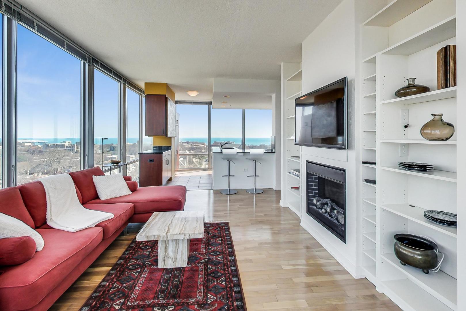 800 Elgin Road, Unit PH02 Evanston, IL 60201 - Photo 16 of 43 a living room with furniture fireplace and flat screen tv