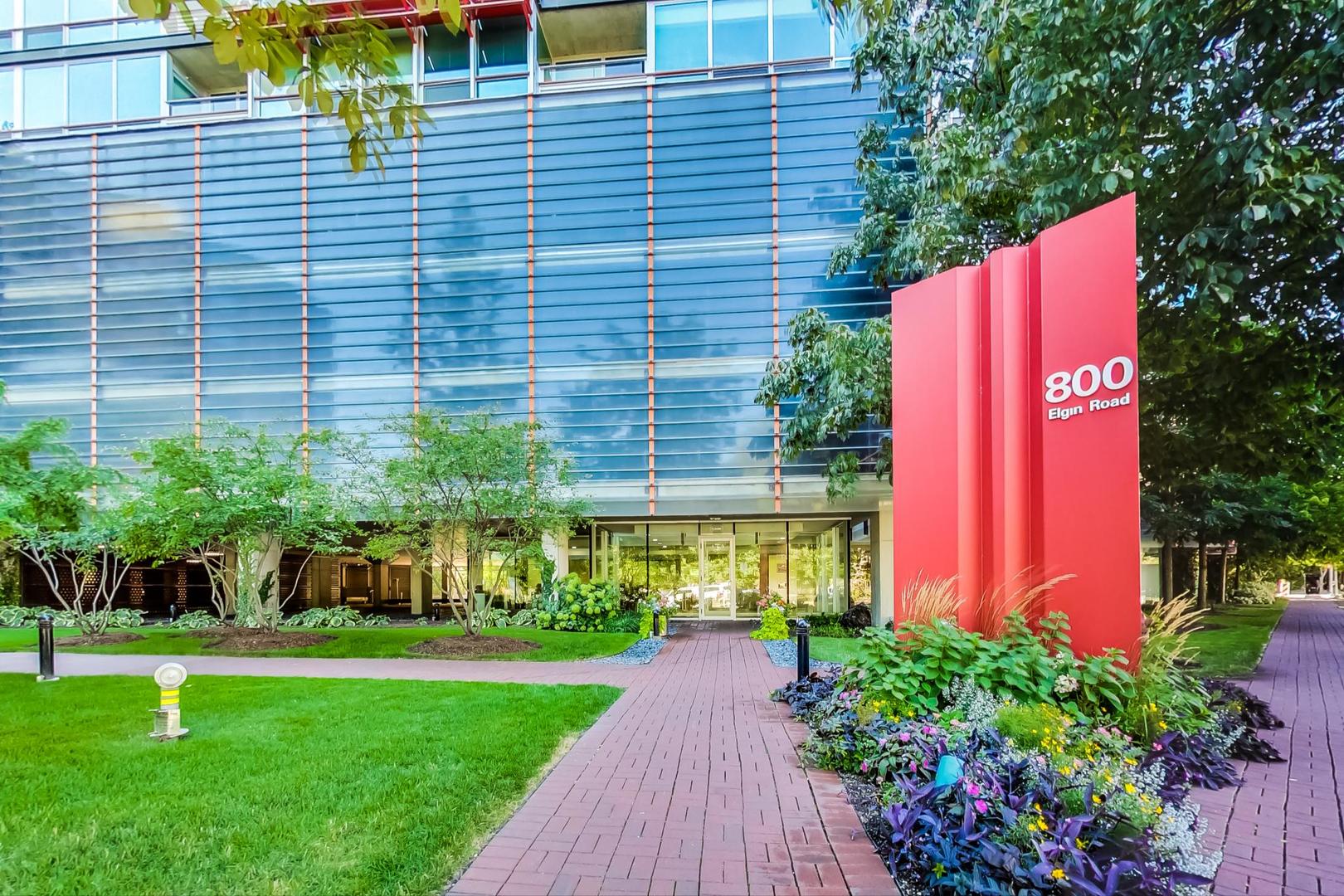 800 Elgin Road, Unit PH02 Evanston, IL 60201 - Photo 2 of 43 a view of a house with a yard and a garage