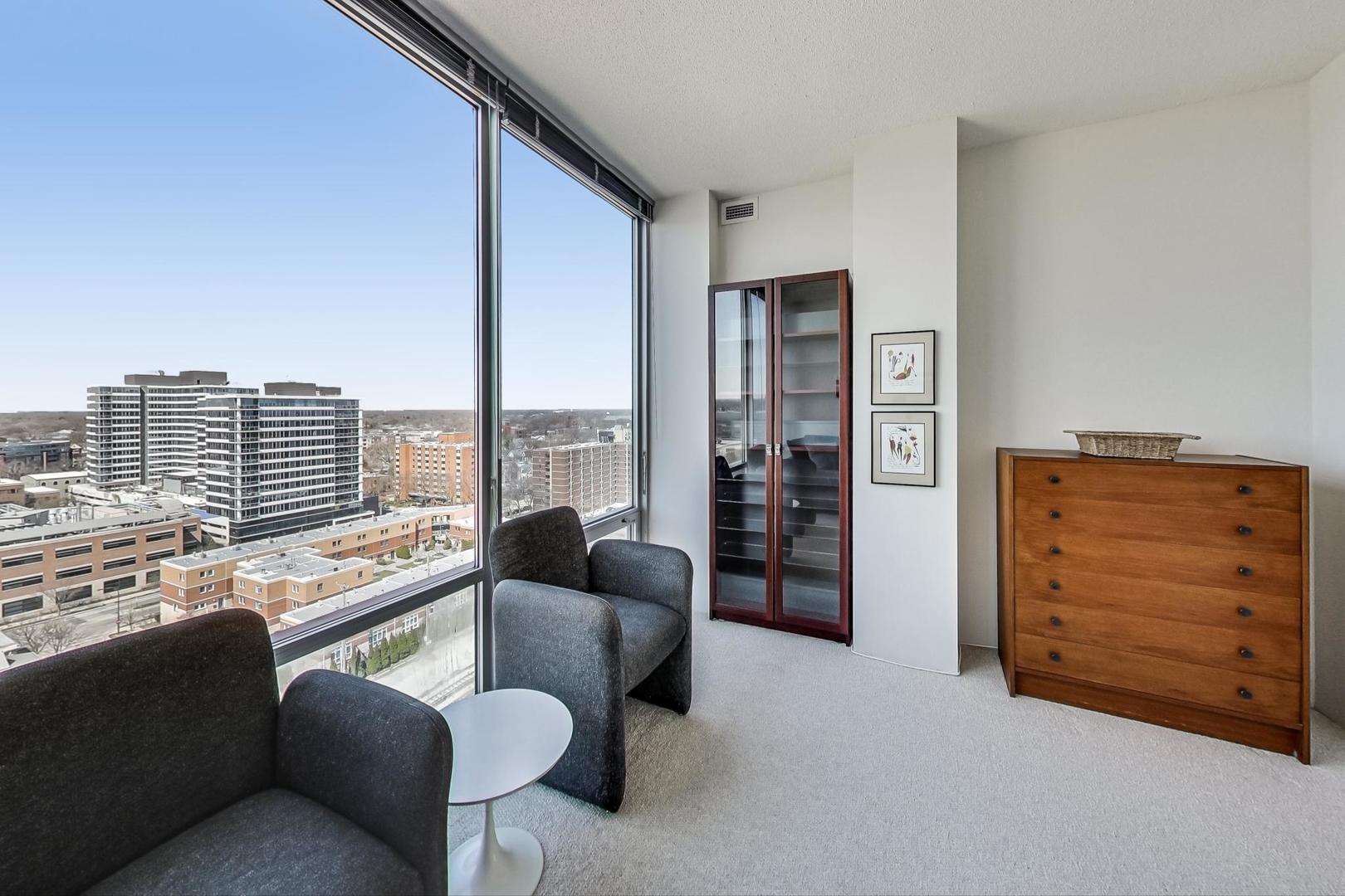 800 Elgin Road, Unit PH02 Evanston, IL 60201 - Photo 30 of 43 a living room with furniture and a floor to ceiling window